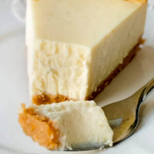 Cheesecake slice, fork with piece of the cheesecake
