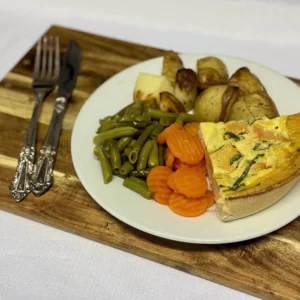 Spinach quiche with roast potatoes, carrots, beans