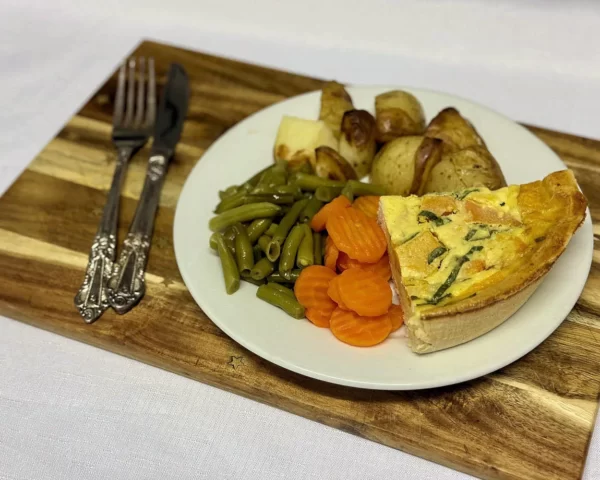 Spinach quiche with roast potatoes, carrots, beans