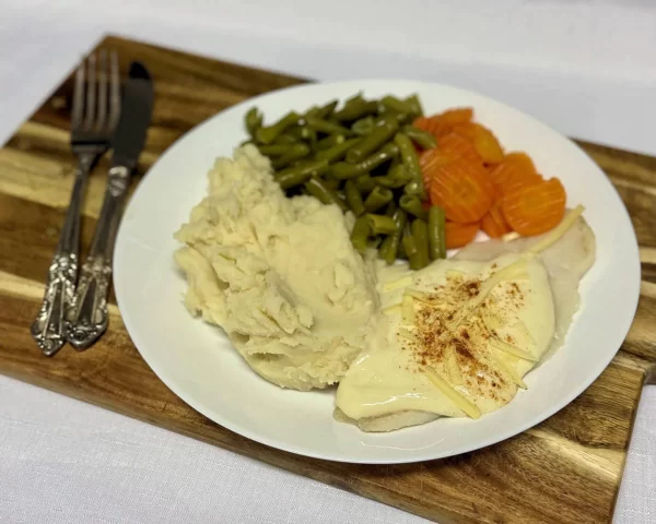 Steamed fish with mornay sauce, mash potato, beans, carrots